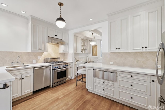2401 Jackson St Unit 3, San Francisco, CA 94115 - kitchen with appliances with stainless steel finishes, a sink, under cabinet range hood, a warming drawer, and decorative light fixtures
