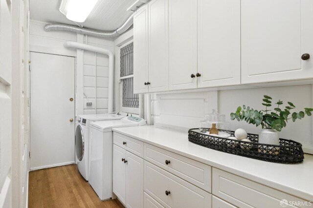 2401 Jackson St Unit 3, San Francisco, CA 94115 - clothes washing area featuring cabinet space, washer and dryer, and light wood-style floors