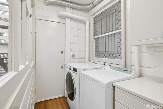 2401 Jackson St Unit 3, San Francisco, CA 94115 - laundry room featuring independent washer and dryer, wood finished floors, and cabinet space