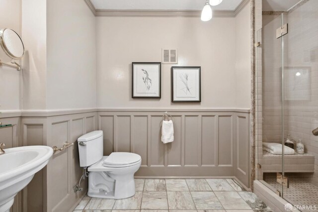 2401 Jackson St Unit 3, San Francisco, CA 94115 - bathroom with a decorative wall, a stall shower, toilet, marble finish flooring, and a sink