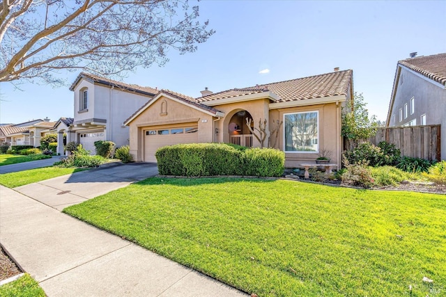 mediterranean / spanish-style home featuring a front lawn, fence, a tile roof, stucco siding, and driveway