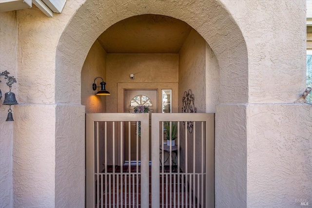 entrance to property featuring stucco siding