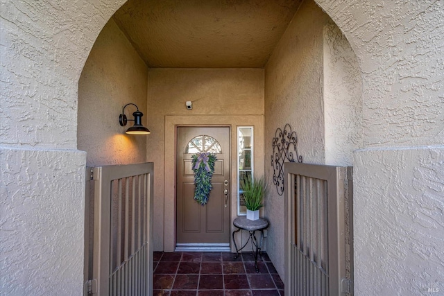 property entrance featuring stucco siding