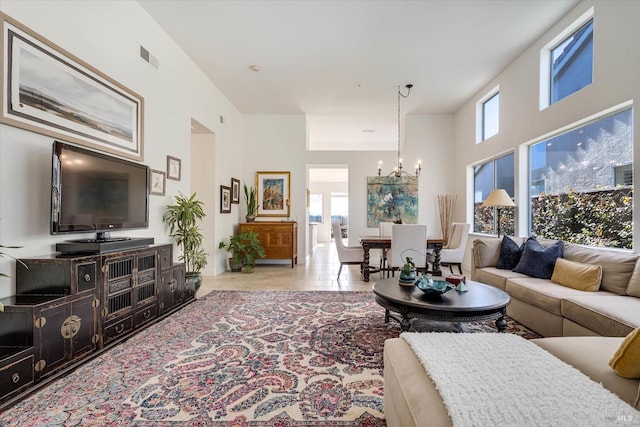 living room with a chandelier, visible vents, and tile patterned flooring