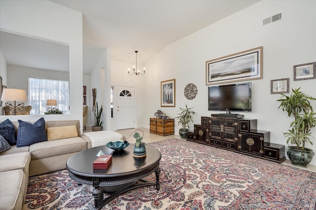 living area featuring vaulted ceiling, visible vents, and a chandelier