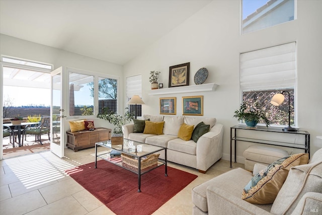 living area featuring light tile patterned flooring and high vaulted ceiling