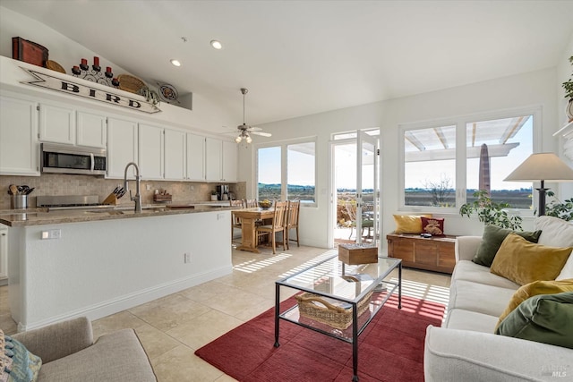 living room with light tile patterned floors, recessed lighting, and a ceiling fan