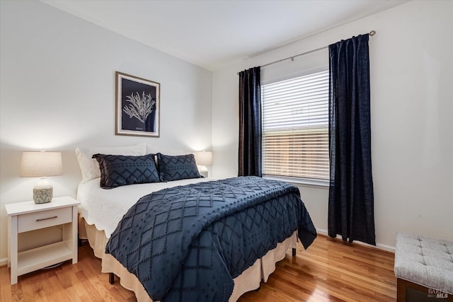 bedroom featuring baseboards and light wood-style floors