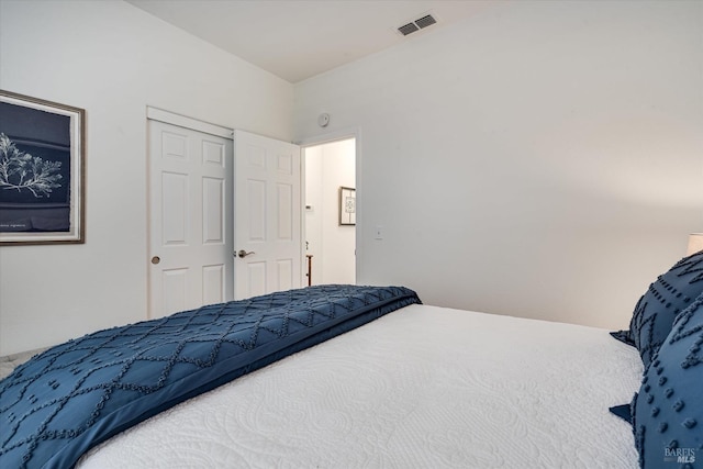 bedroom with visible vents and a closet