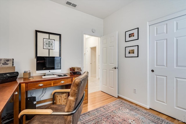 office area with visible vents, baseboards, and light wood finished floors