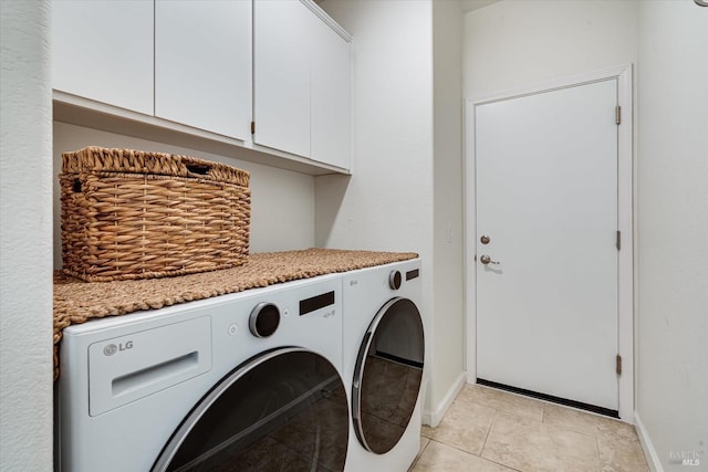 laundry area featuring light tile patterned floors, cabinet space, independent washer and dryer, and baseboards