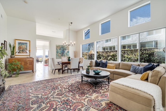 living room featuring a chandelier, light tile patterned floors, and a high ceiling