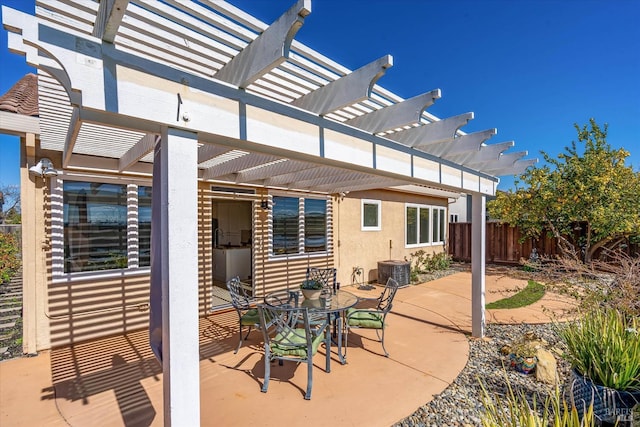 view of patio featuring central AC unit, a pergola, and fence