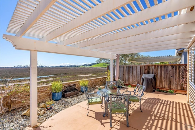 view of patio with area for grilling, outdoor dining space, a pergola, and fence