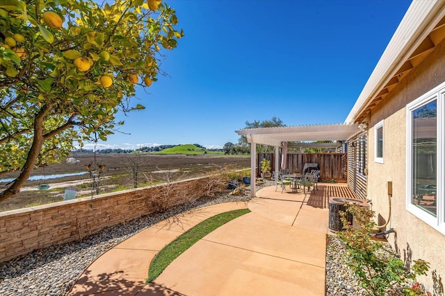 view of patio with cooling unit, fence, and a pergola