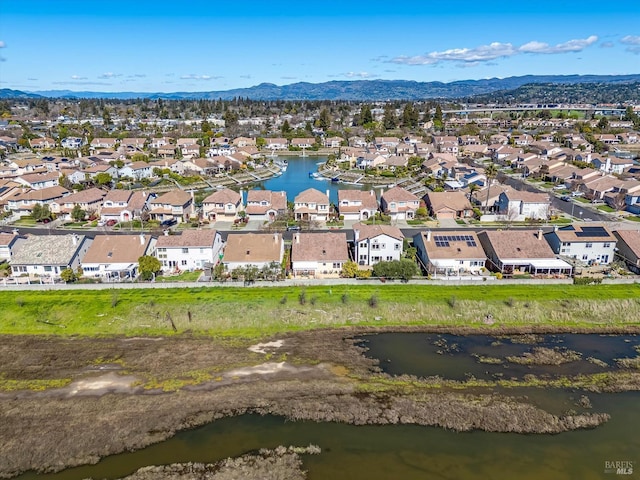 drone / aerial view with a residential view and a water and mountain view