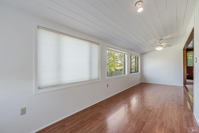 spare room with wood finished floors, ceiling fan, and wooden ceiling