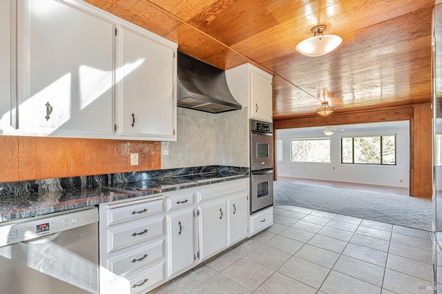 kitchen featuring light tile patterned flooring, dark countertops, decorative backsplash, stainless steel appliances, and range hood