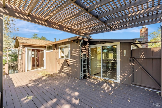 deck featuring a pergola and fence