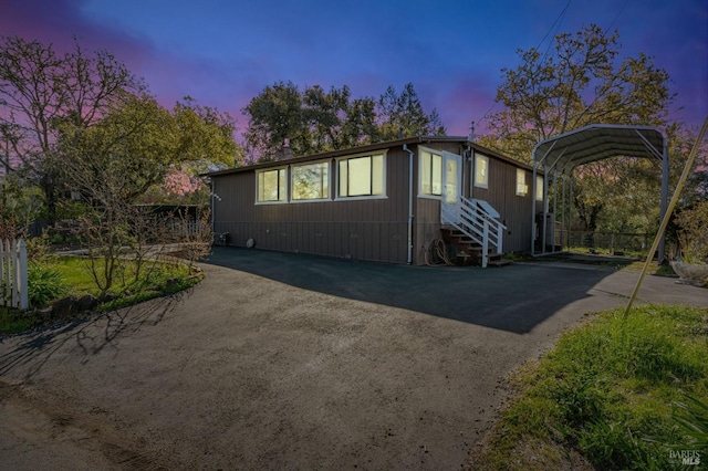 exterior space featuring a detached carport, entry steps, and driveway