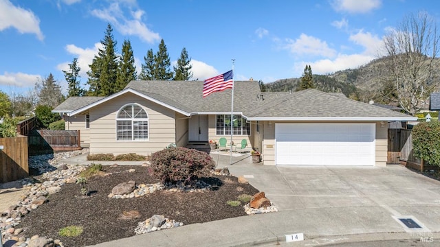 single story home featuring roof with shingles, fence, driveway, and an attached garage