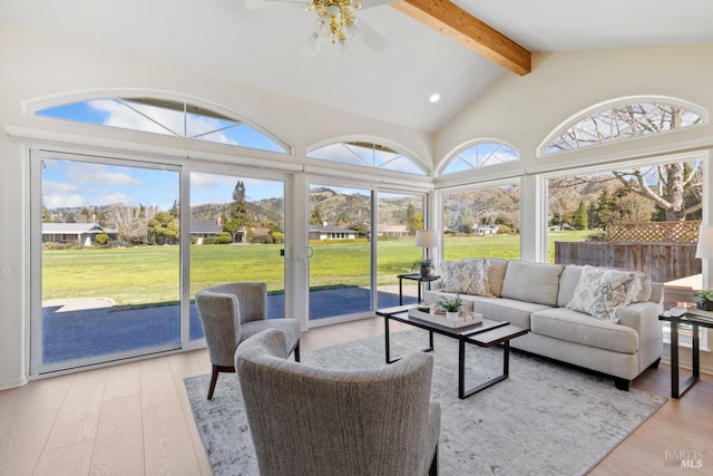 sunroom / solarium with ceiling fan and lofted ceiling with beams