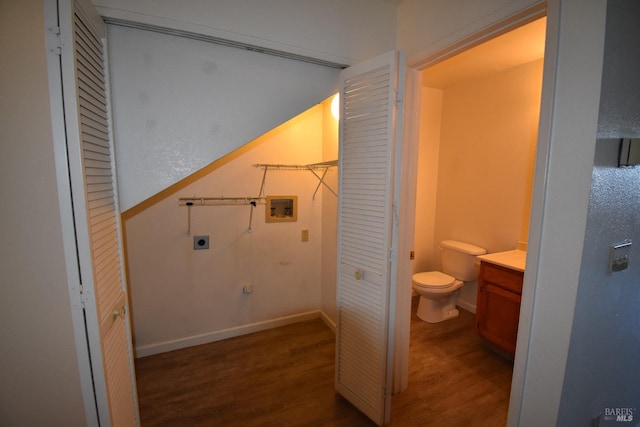 bathroom featuring toilet, wood finished floors, vanity, baseboards, and a closet