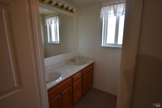 bathroom featuring a sink and double vanity