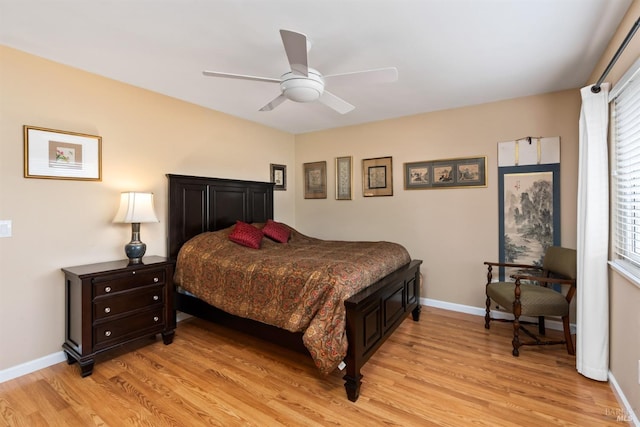 bedroom featuring baseboards, light wood-style floors, and ceiling fan