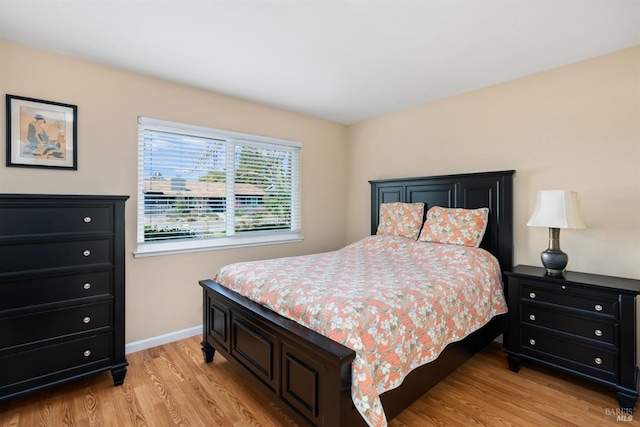 bedroom featuring baseboards and light wood-style floors