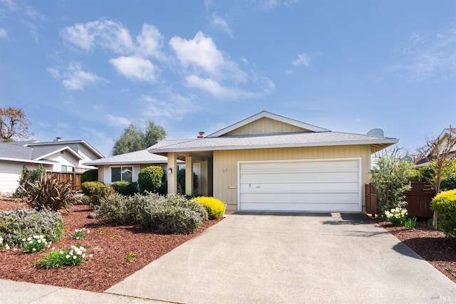 single story home with an attached garage, driveway, and fence