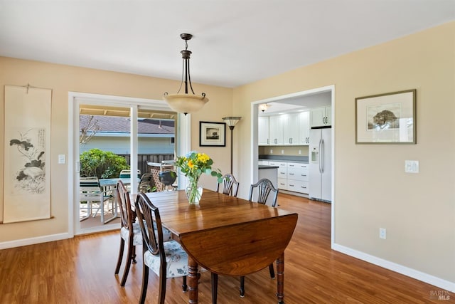 dining room featuring baseboards and wood finished floors