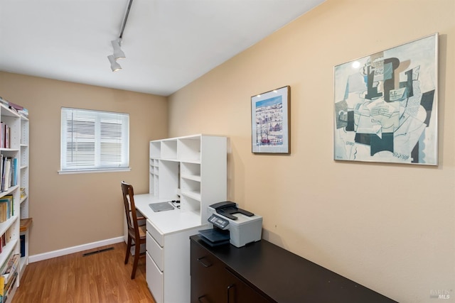 office featuring visible vents, rail lighting, light wood-type flooring, and baseboards