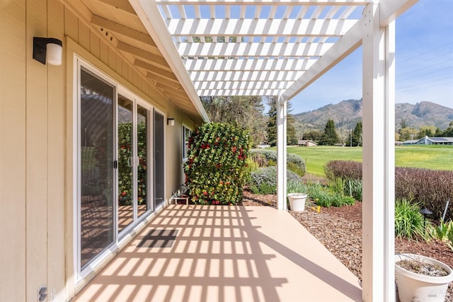 view of patio featuring a mountain view and a pergola