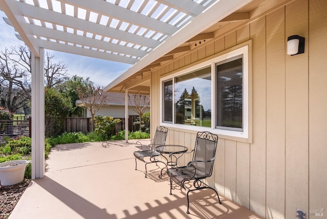 view of patio featuring a pergola and fence