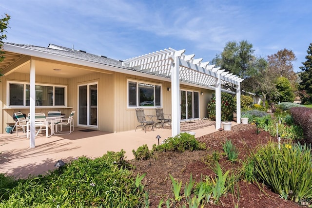 back of property featuring a patio area and a pergola