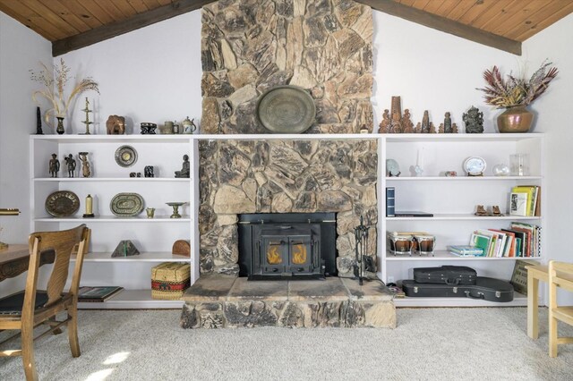 living room featuring a wood stove, wood ceiling, and vaulted ceiling with beams