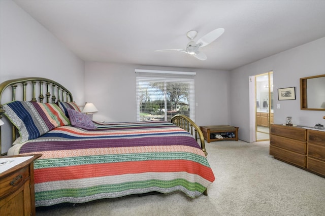 bedroom featuring a ceiling fan, light colored carpet, and connected bathroom