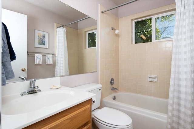 bathroom with plenty of natural light, toilet, shower / bath combo, and vanity