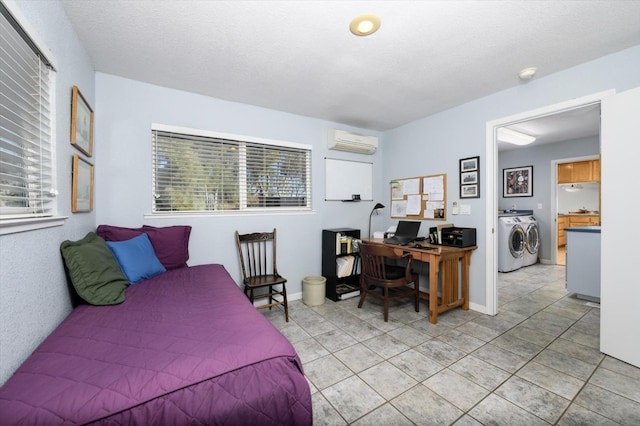 bedroom with light tile patterned flooring, washer and dryer, a wall unit AC, and multiple windows