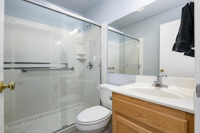 full bathroom featuring toilet, a stall shower, and vanity