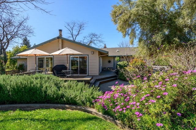 back of property featuring a deck