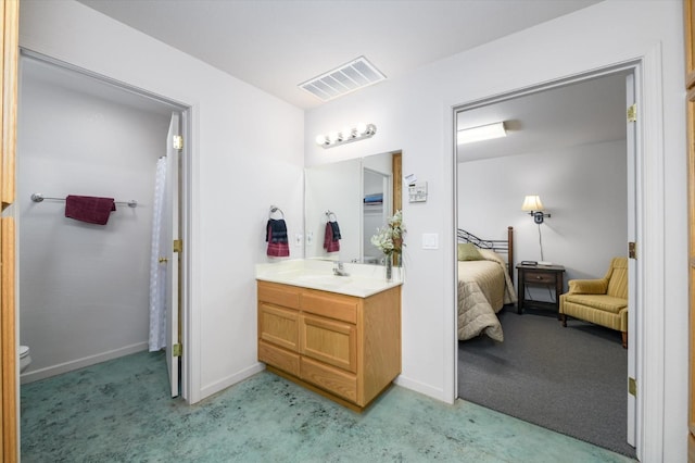 bathroom with vanity, baseboards, visible vents, toilet, and connected bathroom