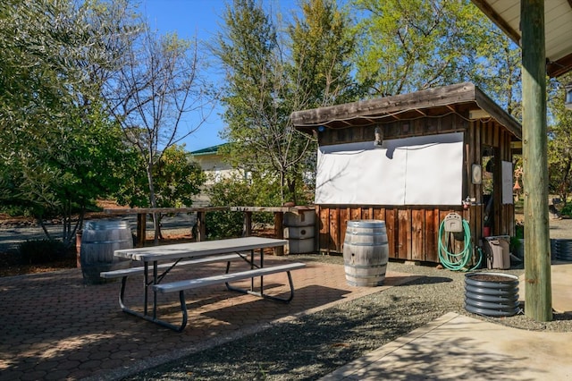 view of patio with an outbuilding