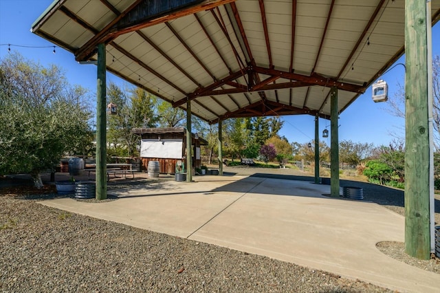 view of patio / terrace featuring an outbuilding and driveway