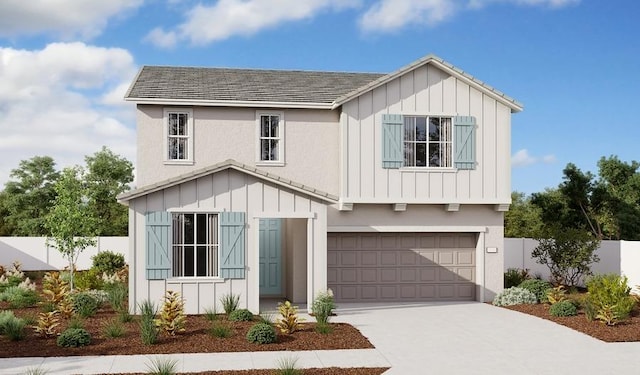 view of front facade with board and batten siding, concrete driveway, fence, and a garage