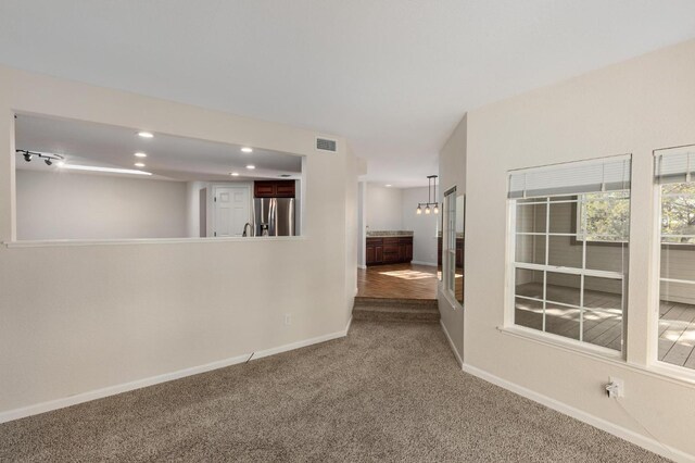 empty room with recessed lighting, carpet, visible vents, and baseboards
