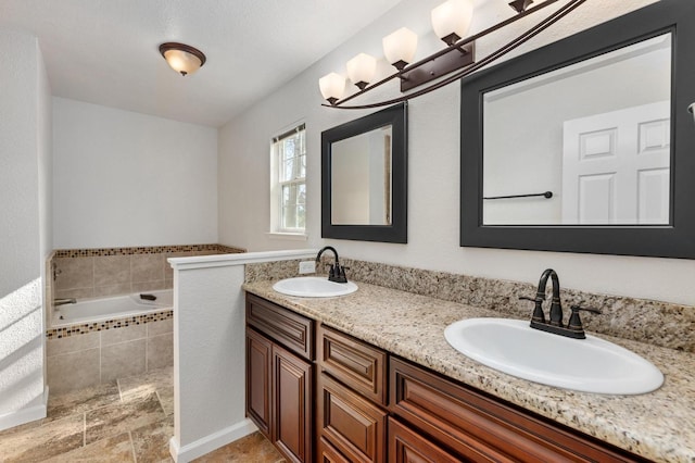 bathroom featuring double vanity, a sink, and tiled bath