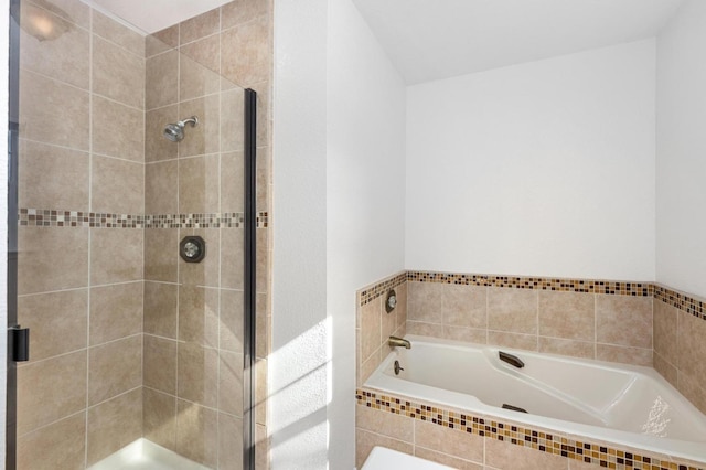 bathroom with a garden tub and a stall shower