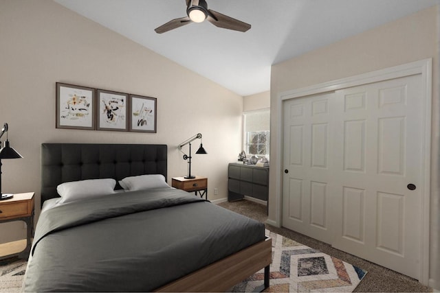 bedroom with ceiling fan, a closet, carpet floors, lofted ceiling, and baseboards